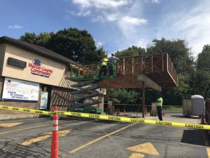 Workers doing demo on drive thru canopy