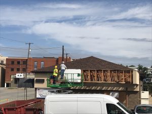 Workers taking down drive thru canopy