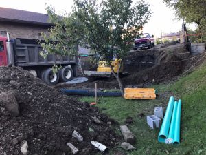 digging foundation for new addition at back of existing building