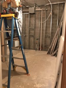 Worker on ladder inside building