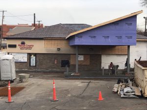 Picture of new drive-thru canopy and workers pouring concrete.