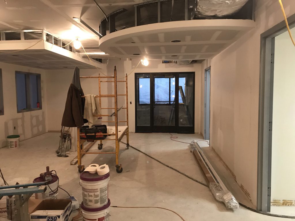 View of new MSR desk area in lobby by entrance. Drywall materials. Drywall is almost done.