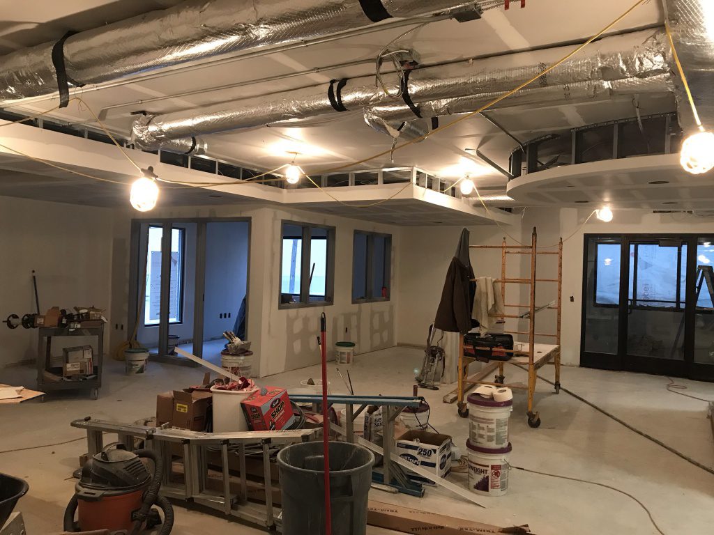 View of new office and lobby area with drywall materials.