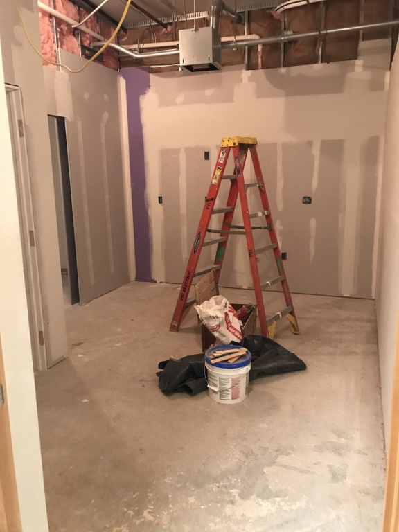 Photo of ladder and drywall materials in new employee break room