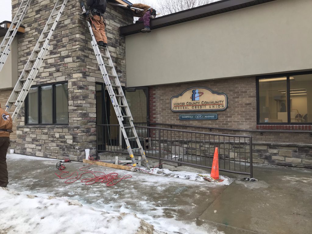 New entryway with workers on ladders