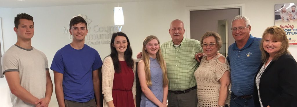 Photo of scholarship winners with members of the board of directors and the CEO.